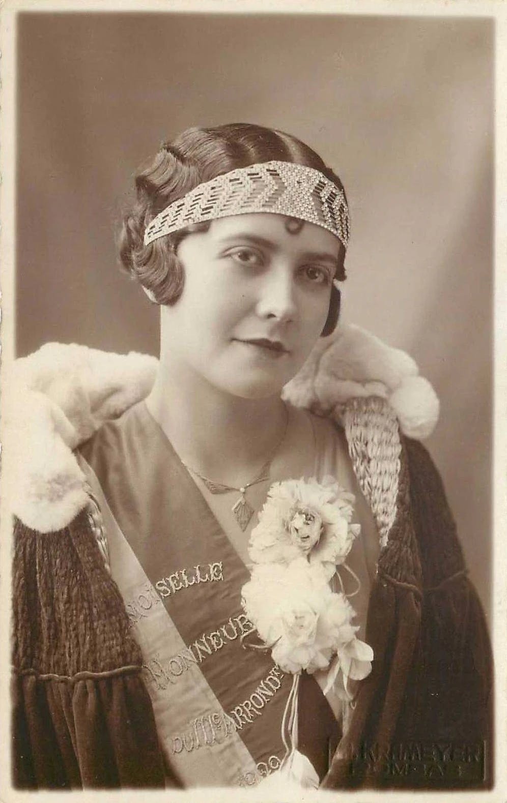 French woman wearing beaded bandeau, 1929. Public domain, via Wikimedia Commons.