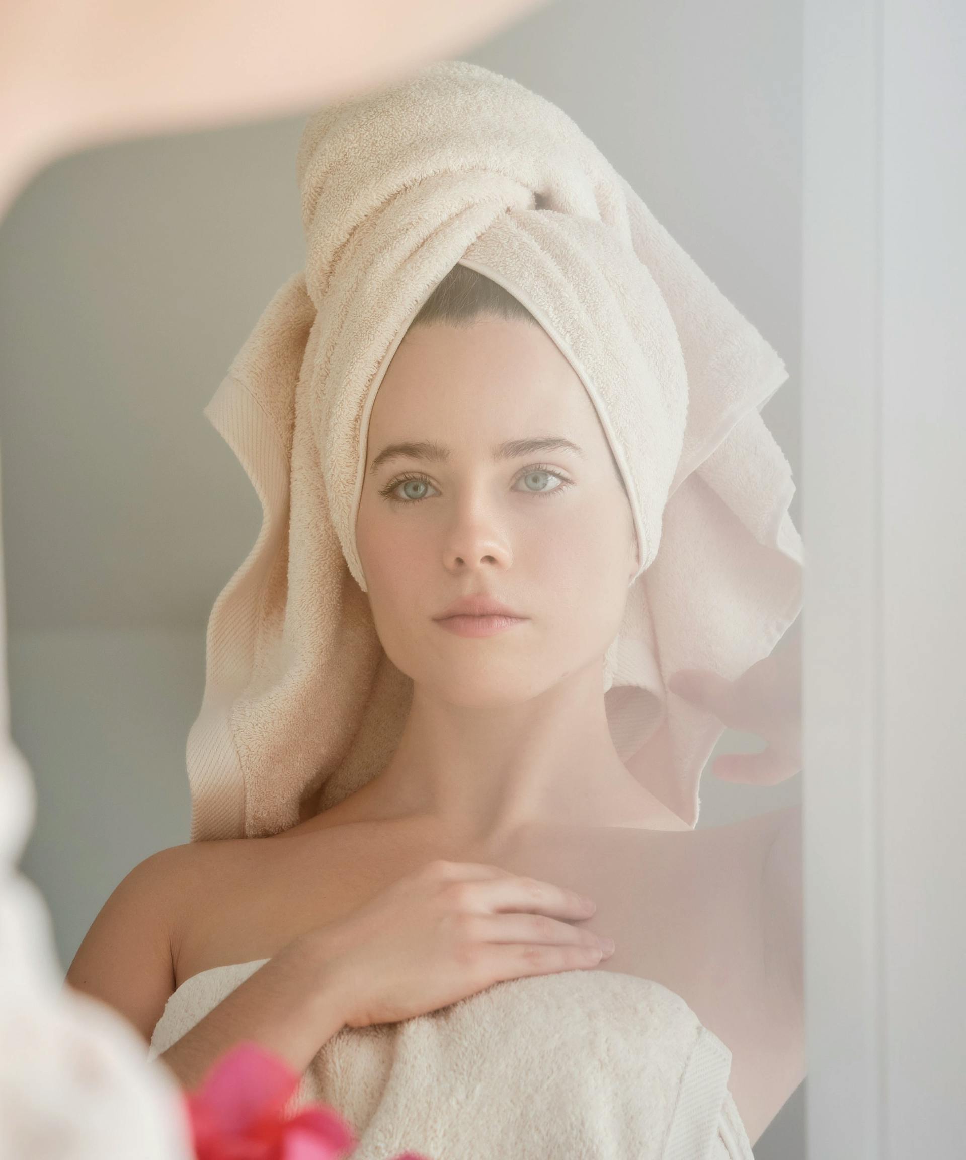 Woman looking in mirror > Shutterstock