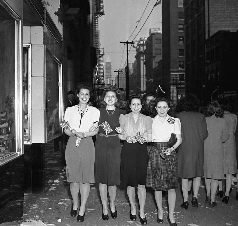 Women celebrating VE Day in Toronto, Canada. 1945. Alexandra Studios, Public domain, via Wikimedia Commons.