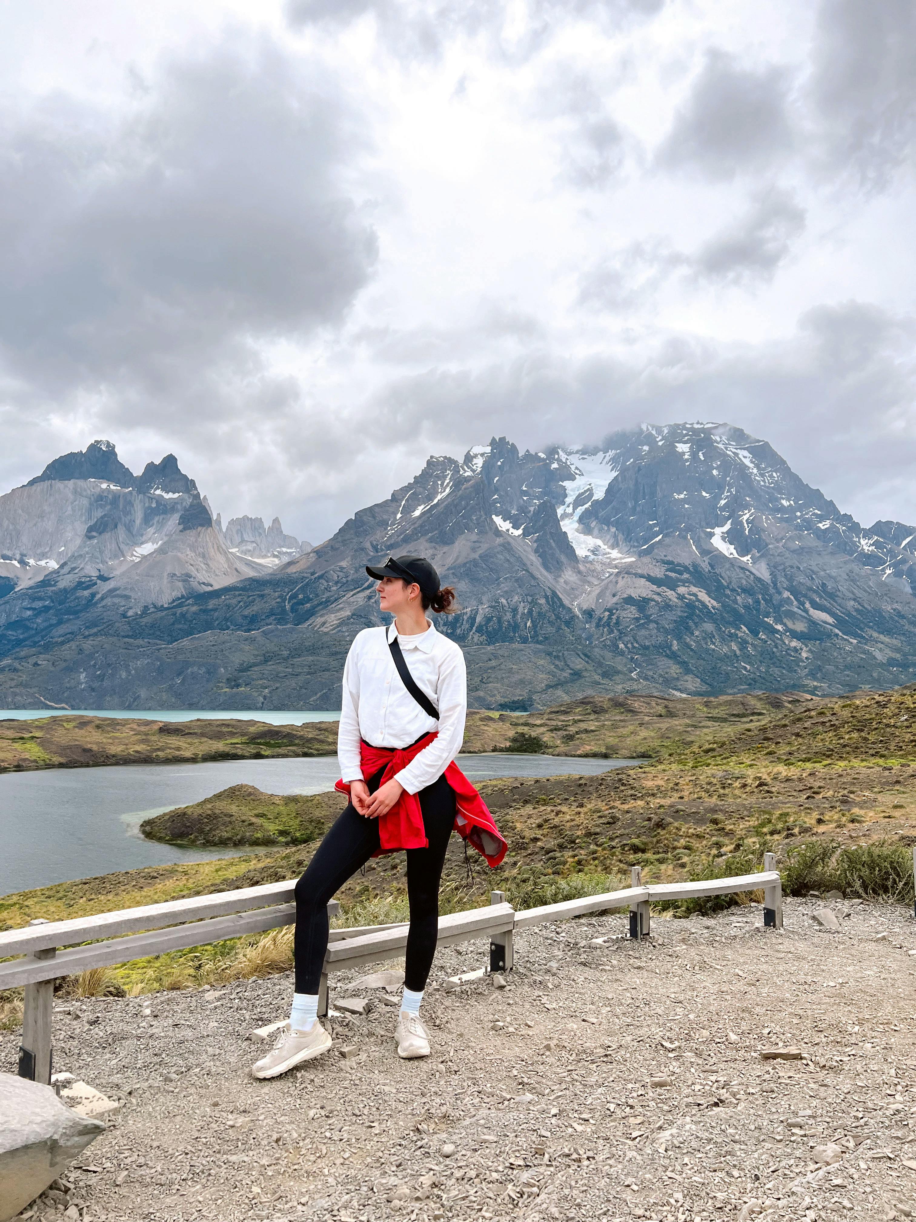 Alyssa stands in front of a mountain range in Patagonia.